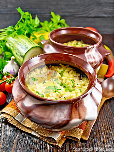 Image of Rice with chicken and vegetables in two pots on towel