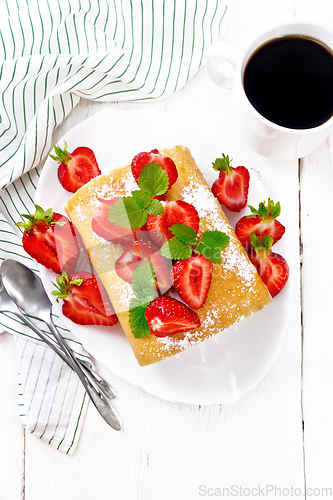 Image of Roll with cream and strawberries in plate on board top