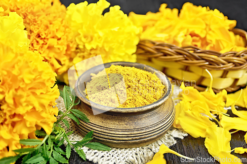 Image of Saffron imerta in bowl with petals on black board