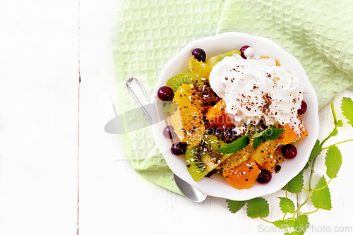 Image of Salad fruit with cranberries in bowl on board top