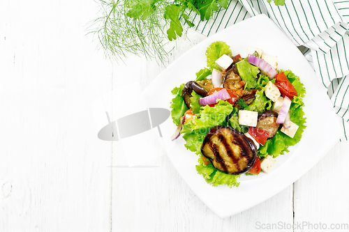 Image of Salad of eggplant with cheese and tomatoes on light board top