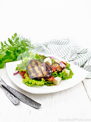 Image of Salad of eggplant with cheese and tomatoes on table