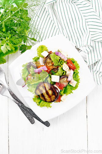 Image of Salad of eggplant with cheese and tomatoes on white board top