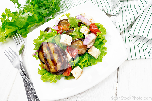 Image of Salad of eggplant with cheese and tomatoes on white board