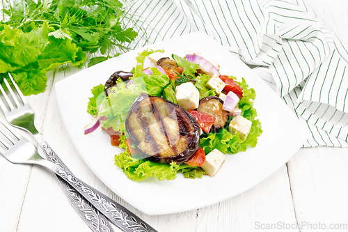 Image of Salad of eggplant with cheese and tomatoes on wooden board