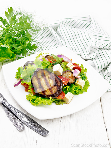 Image of Salad of eggplant with cheese and tomatoes on wooden table