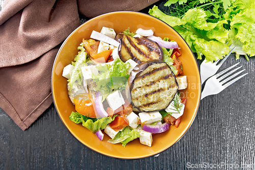 Image of Salad of eggplant with feta and tomatoes on dark board top