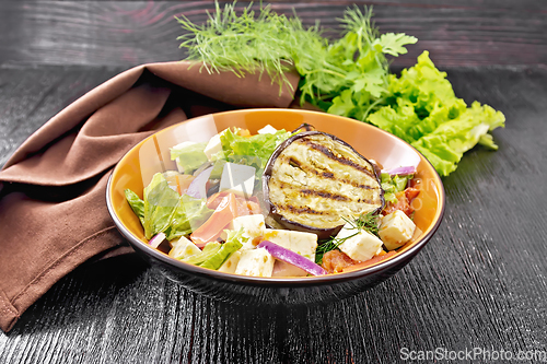 Image of Salad of eggplant with feta and tomatoes on dark board