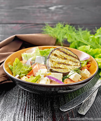 Image of Salad of eggplant with feta and tomatoes on wooden board