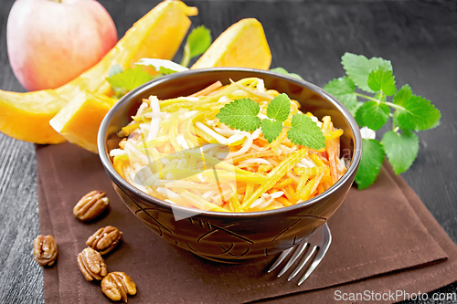 Image of Salad of pumpkin and apple in bowl on black board