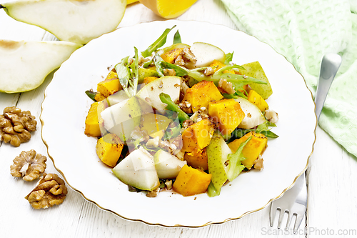 Image of Salad of pumpkin and pear in plate on white board