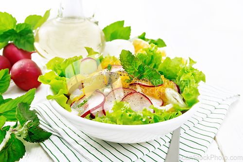 Image of Salad of radish and orange with mint on board