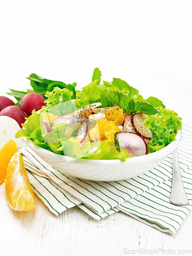 Image of Salad of radish and orange with mint on wooden board