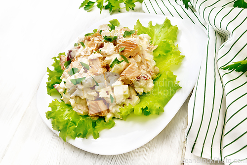 Image of Salad of salmon and cucumber in plate on white board