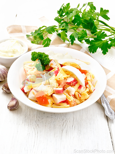 Image of Salad of surimi and tomatoes with eggs on table