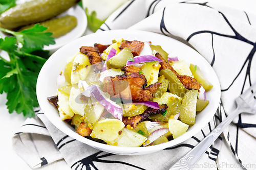 Image of Salad potato with bacon and cucumber in plate on board
