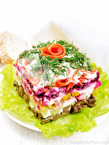 Image of Salad with beef and vegetables on white wooden board