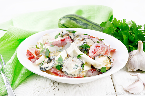 Image of Salad with fried zucchini in plate on board