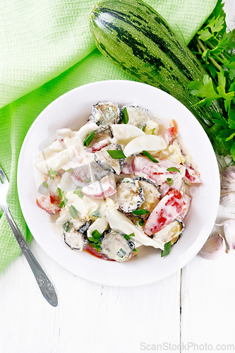 Image of Salad with fried zucchini in plate on light board top