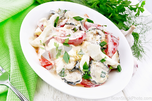 Image of Salad with fried zucchini in plate on white board