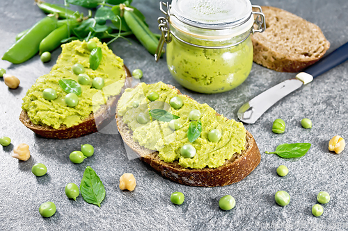 Image of Sandwich green pea hummus on stone dark table