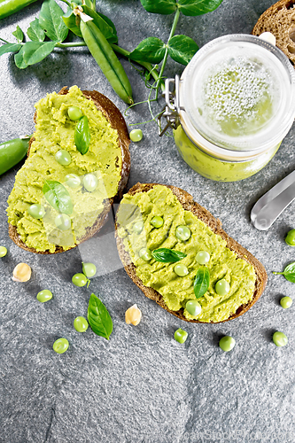 Image of Sandwich green pea hummus on stone granite table top