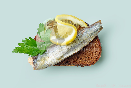 Image of canned sardine on bread slice