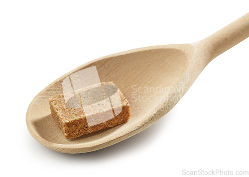 Image of instant beef broth cube in wooden spoon