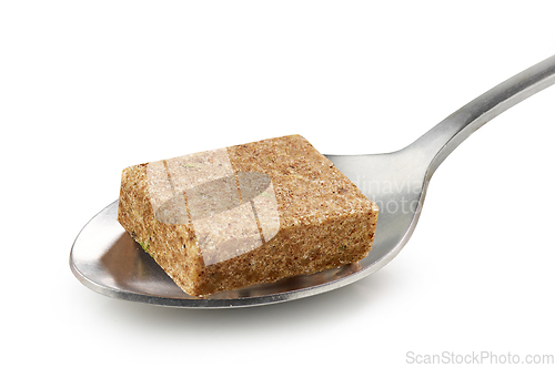 Image of instant beef broth cube in a spoon