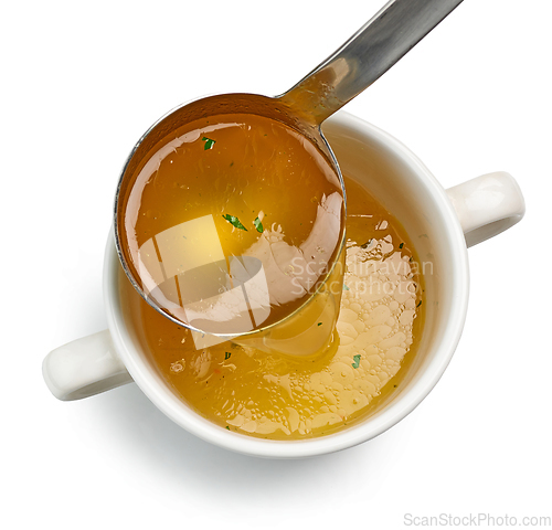 Image of chicken broth pouring into bowl