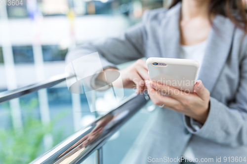 Image of Businesswoman working on cellphone