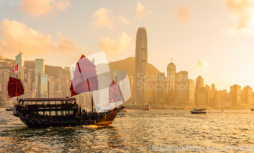 Image of Chinese wooden red sails ship in Hong Kong Victoria harbor at su