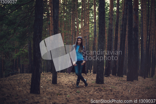 Image of Woman in the autumn dark forest