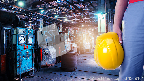 Image of Closeup of worker man with yellow helmet