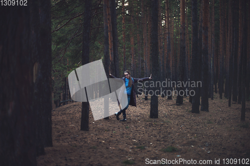 Image of Woman in the autumn dark forest