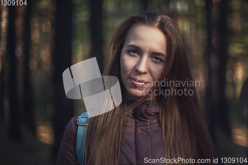 Image of Pretty happy woman in forest