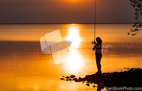 Image of Woman fishing on Fishing rod spinning in Finland