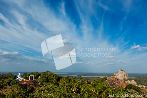 Image of Meditation rock in Mihintale and Buddha Statue on sunset, Sri Lanka