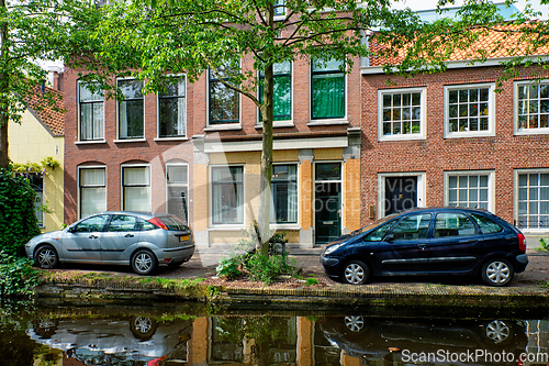 Image of Cars on canal embankment in street of Delft. Delft, Netherlands