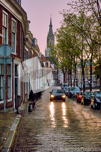 Image of Delft cobblestone street with car in the rain