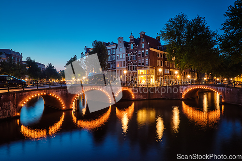 Image of Amterdam canal, bridge and medieval houses in the evening