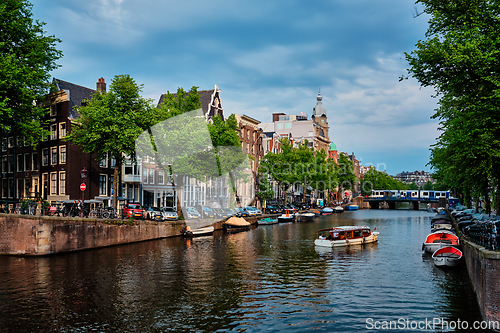 Image of Amsterdam view - canal with boad, bridge and old houses