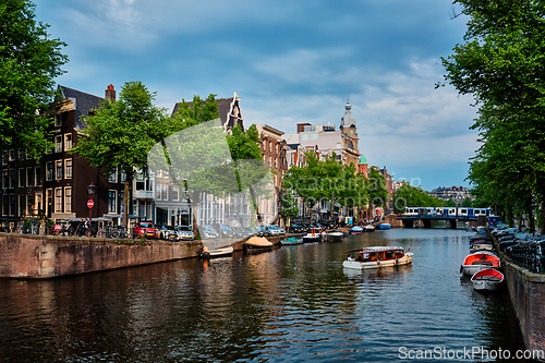 Image of Amsterdam view - canal with boad, bridge and old houses