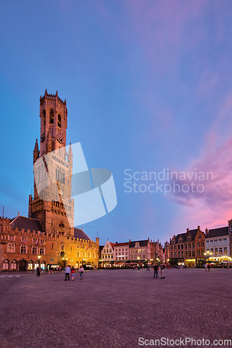 Image of Belfry tower and Grote markt square in Bruges, Belgium on dusk in twilight