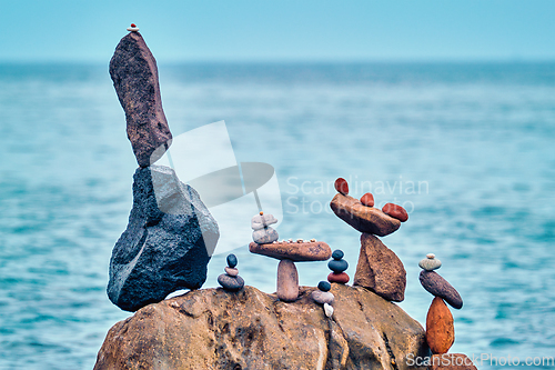 Image of Concept of balance and harmony - pebble stone stacks on the beach