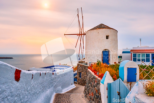 Image of Old greek windmill on Santorini island in Oia town with stairs in street. Santorini, Greece