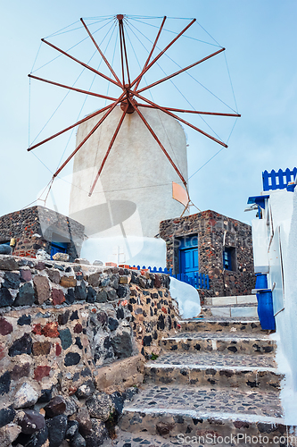 Image of Old greek windmill on Santorini island in Oia town with stairs in street. Santorini, Greece