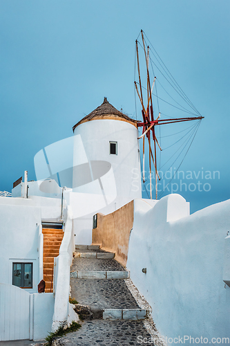 Image of Old greek windmill on Santorini island in Oia town with stairs in street. Santorini, Greece
