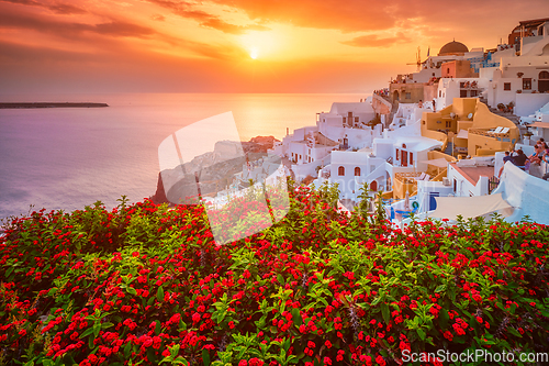 Image of Sunset over Oia town on Santorini island in summer. Santorini, Greece