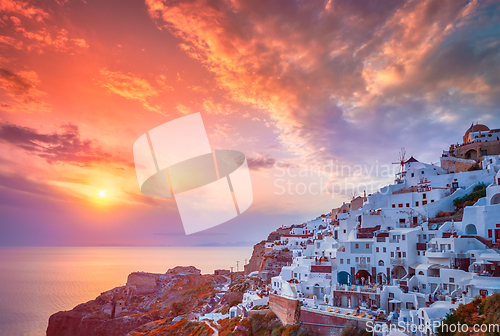 Image of Sunset over Oia town on Santorini island in summer. Santorini, Greece